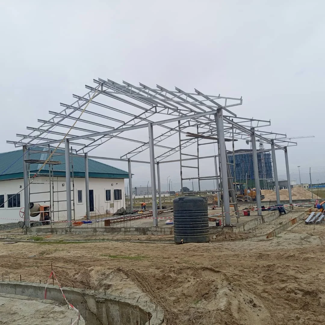Structural steel frame under construction on an active project site