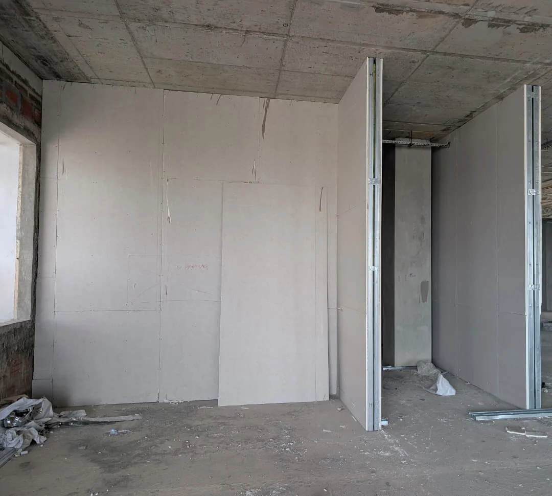Installed drywall partitions with metal stud framing during interior construction